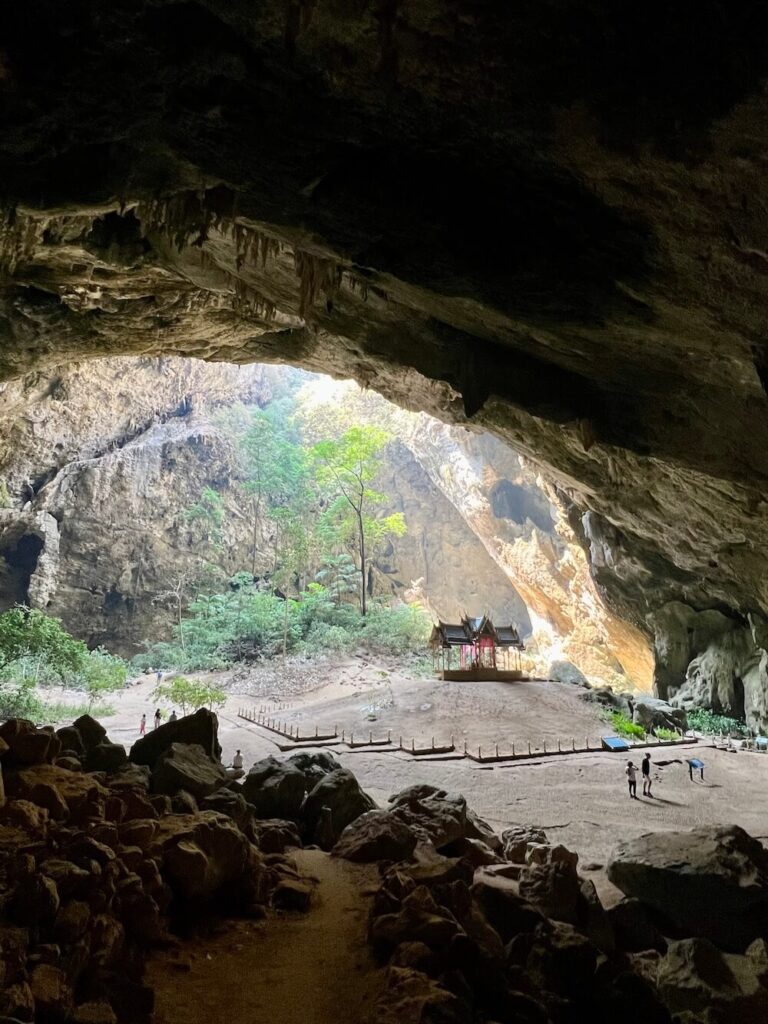 Inside Phraya Nakhon Cave, the Khuha Kharuehat Royal Pavilion sits centered on the floor of the massive, jungle-filled doline chamber beneath the skylight.