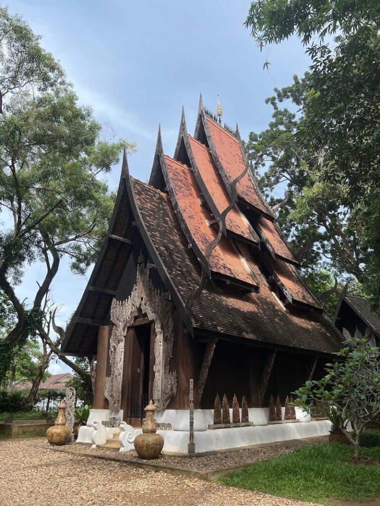 Traditional dark teak building at Baan Dam Black House Museum Chiang Rai