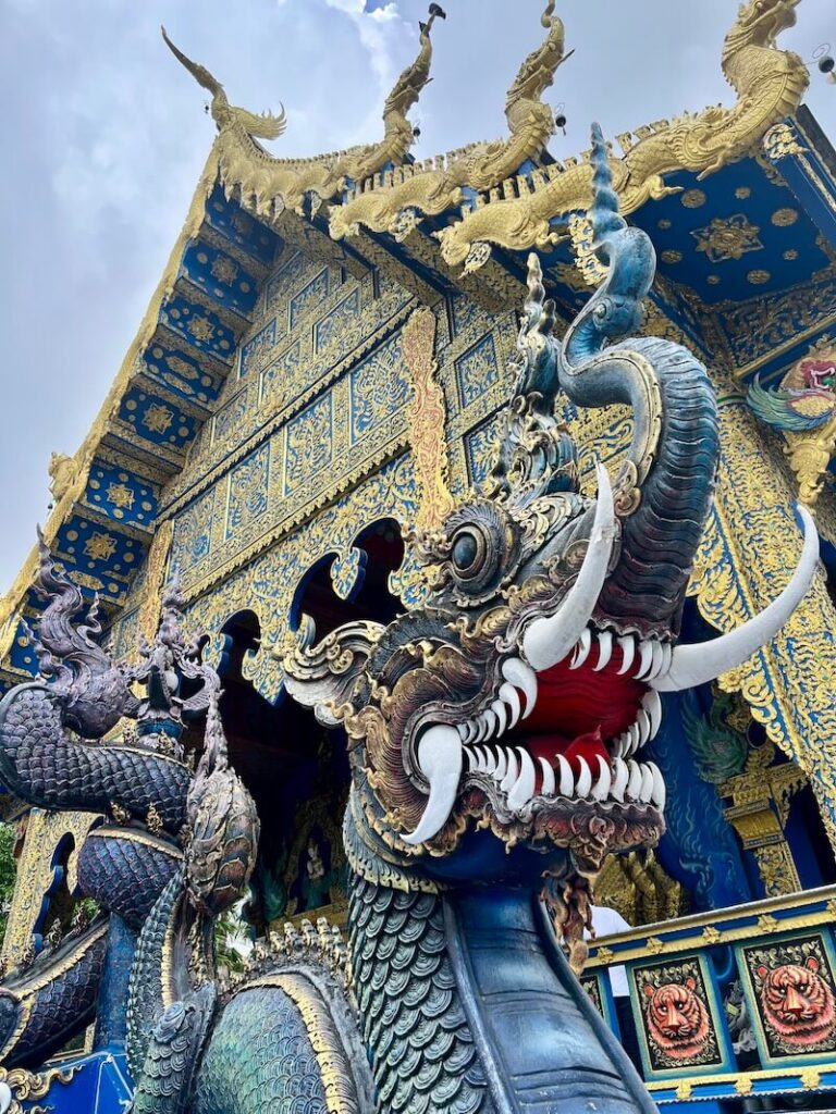 Blue and gold Naga statue at the Blue Temple Wat Rong Suea Ten Chiang Rai