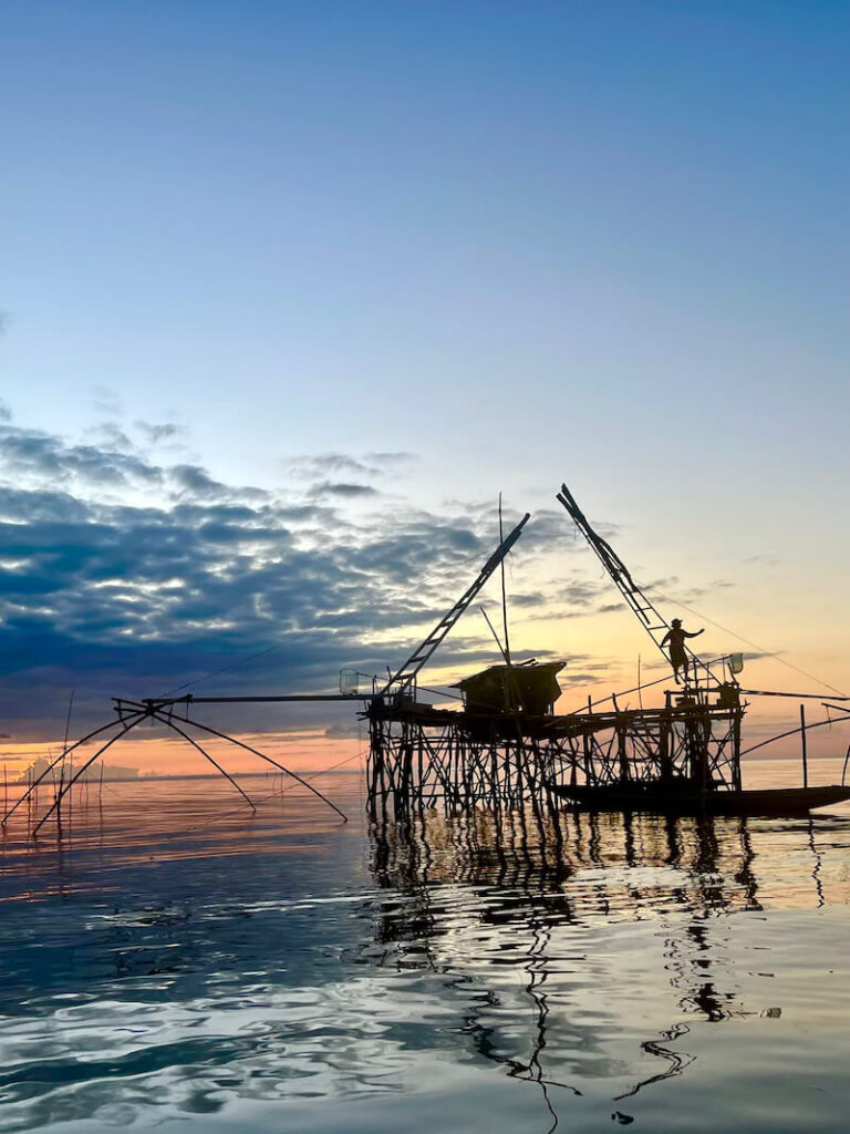 Stunning sunrise view of traditional Yor fishing nets in the Thale Noi wetlands, Phatthalung, Thailand.