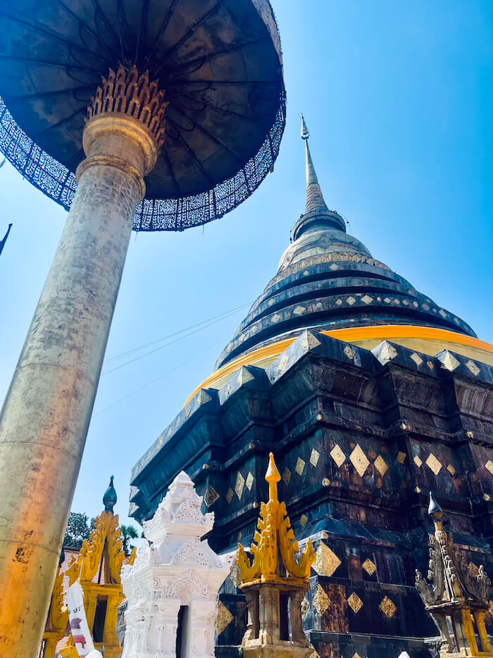 Wat Phrathat Lampang Luang Chedi A low-angle view of the large copper and bronze covered chedi at Wat Phrathat Lampang Luang under a clear blue sky.