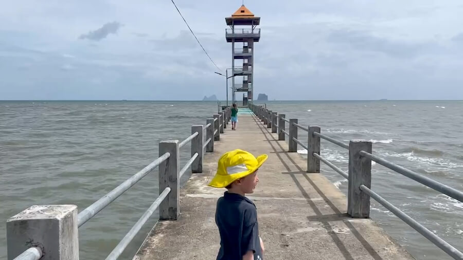 The Hunt for Dugongs A long concrete pier leading to a four-story grey observation tower on Koh Libong, used for spotting dugongs in the shallow sea.