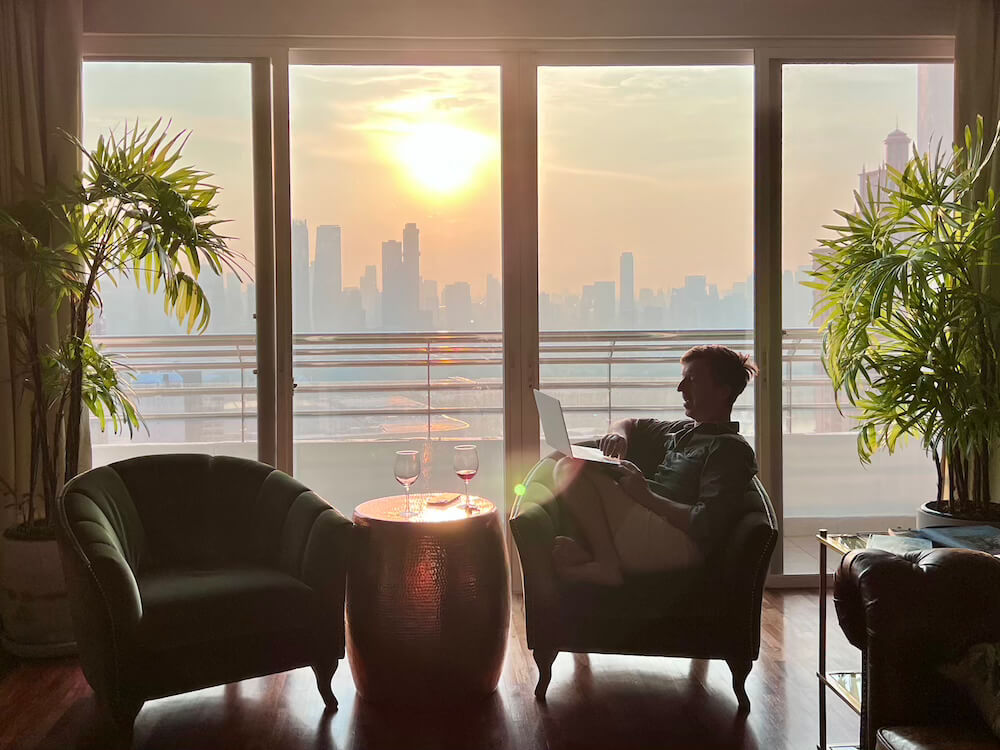 Working on Laptop at Sunset with City View